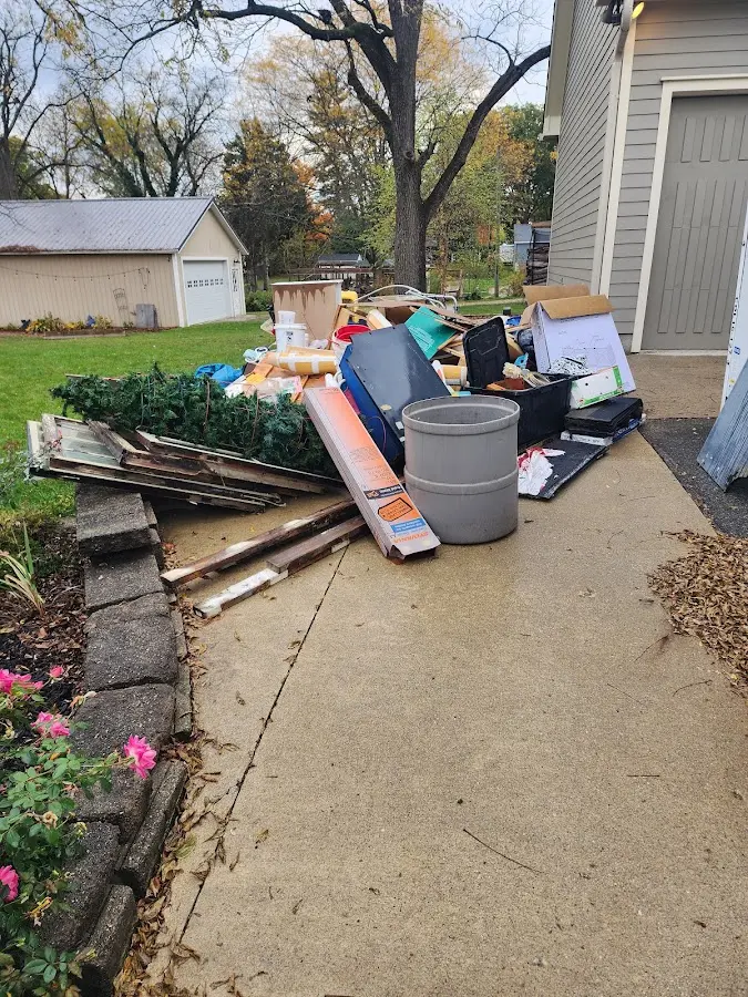 Dumpster being loaded with debris for 10 Yard Dumpster Rental in Elgin